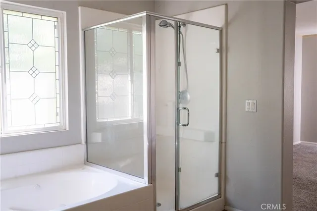 a view of a chandelier fan and wooden floor