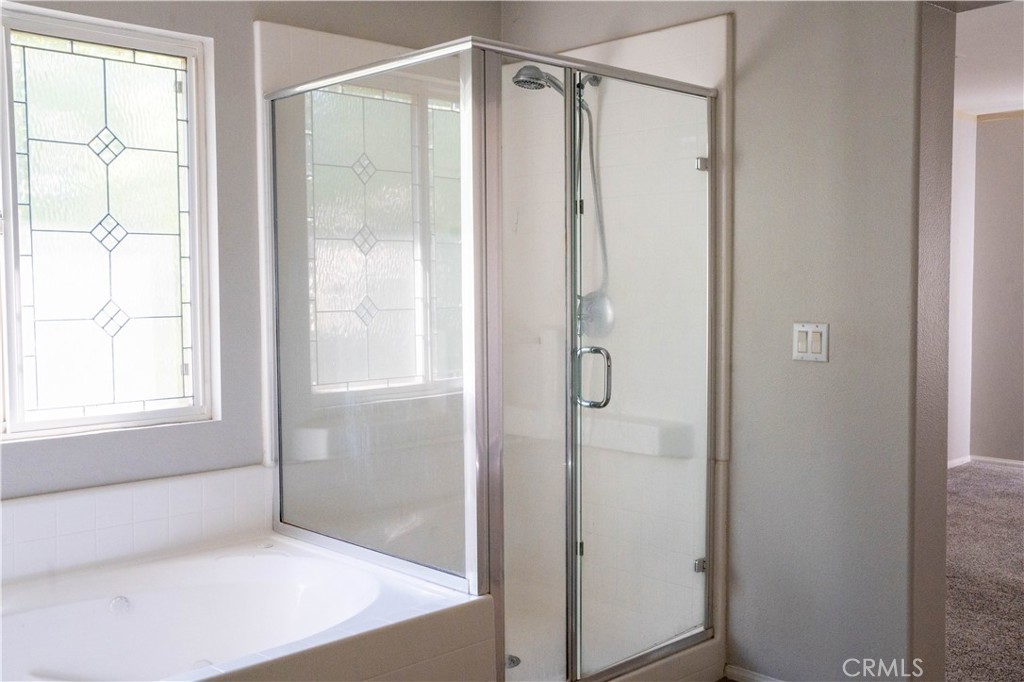 36719 Torrey Pines Drive Beaumont, CA 92223 - Photo 43 of 56 a bathroom with a glass shower door