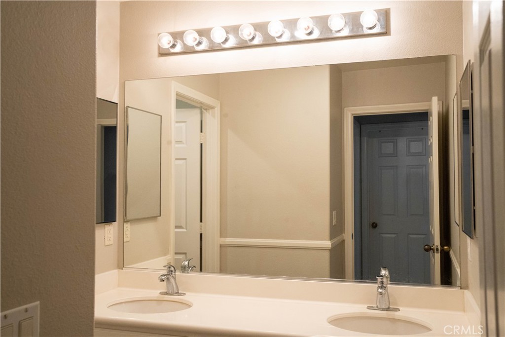 36719 Torrey Pines Drive Beaumont, CA 92223 - Photo 44 of 56 a bathroom with a sink and a mirror
