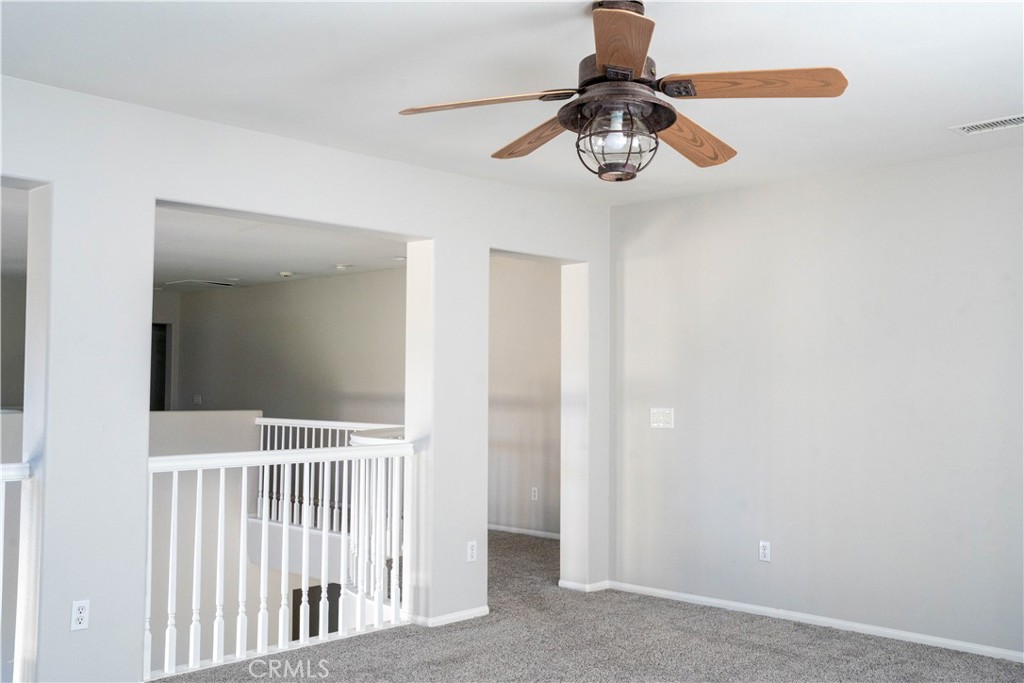 36719 Torrey Pines Drive Beaumont, CA 92223 - Photo 47 of 56 a view of a chandelier fan and wooden floor
