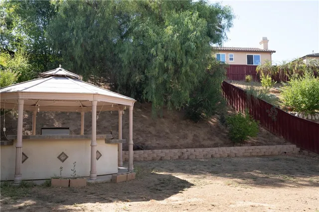 a view of a house with a yard and sitting area