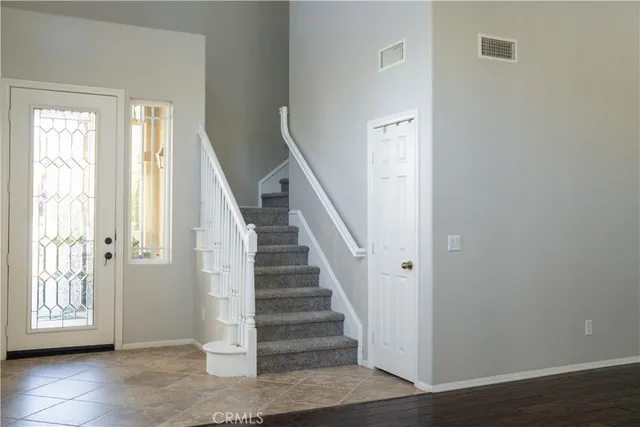 hallway view with wooden floor and stairs