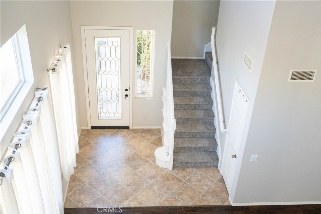 36719 Torrey Pines Drive Beaumont, CA 92223 - Photo 7 of 56 hallway view with wooden floor and stairs