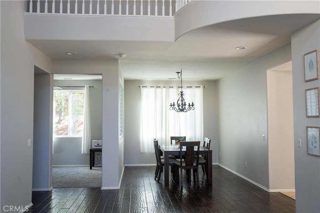 36719 Torrey Pines Drive Beaumont, CA 92223 - Photo 10 of 56 a view of a dining room with furniture and wooden floor