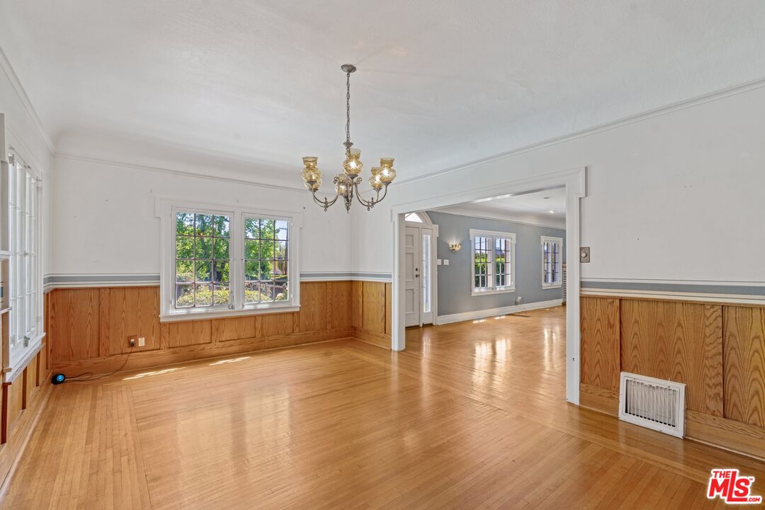 2429 North Commonwealth Avenue Los Angeles, CA 90027 - Photo 15 of 54 a view of an empty room with window and wooden floor