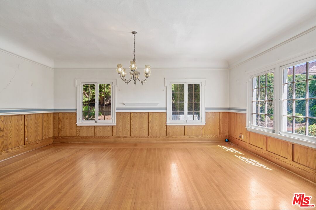 2429 North Commonwealth Avenue Los Angeles, CA 90027 - Photo 17 of 54 a view of an empty room with wooden floor and a window