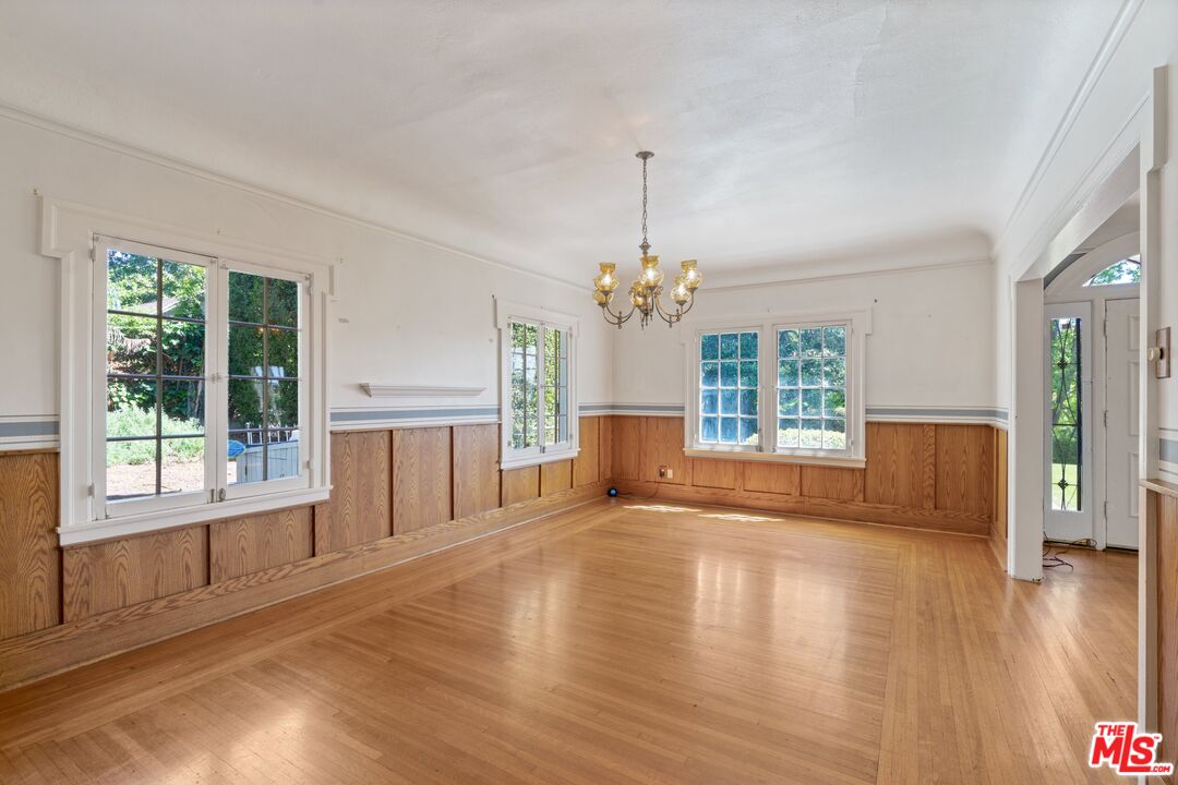 2429 North Commonwealth Avenue Los Angeles, CA 90027 - Photo 18 of 54 a view of an empty room with a window and wooden floor