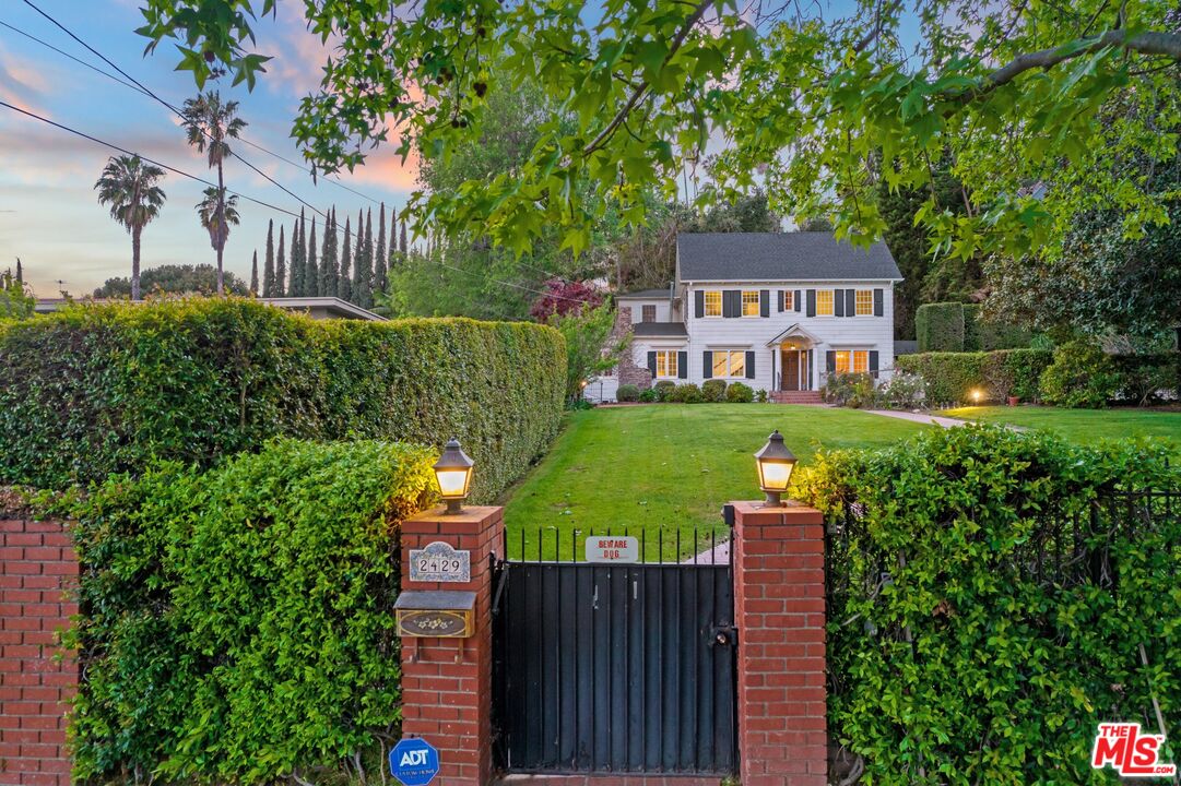 2429 North Commonwealth Avenue Los Angeles, CA 90027 - Photo 2 of 54 a front view of a house with a yard table and chairs