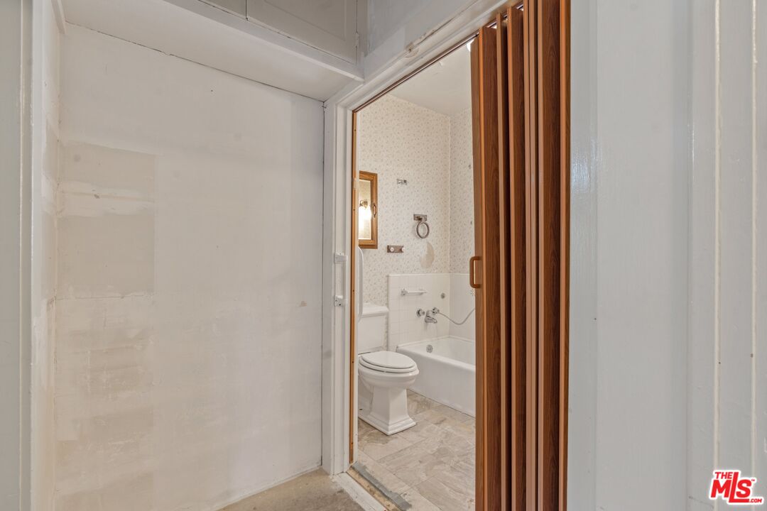 2429 North Commonwealth Avenue Los Angeles, CA 90027 - Photo 24 of 54 a bathroom with a granite countertop toilet and a sink