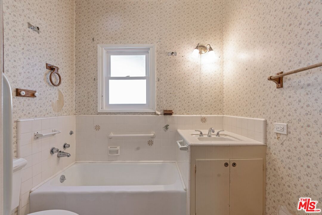2429 North Commonwealth Avenue Los Angeles, CA 90027 - Photo 29 of 54 a bathroom with a tub sink and mirror