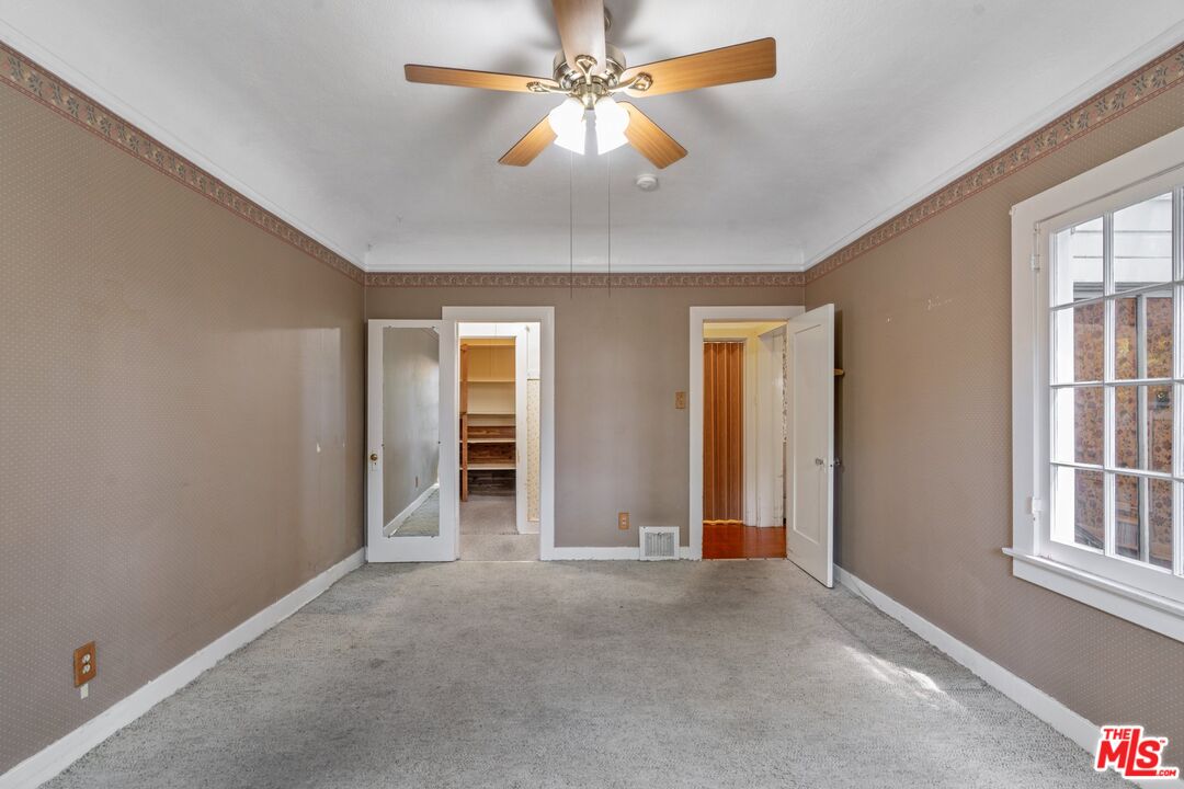 2429 North Commonwealth Avenue Los Angeles, CA 90027 - Photo 30 of 54 an empty room with chandelier fan and windows