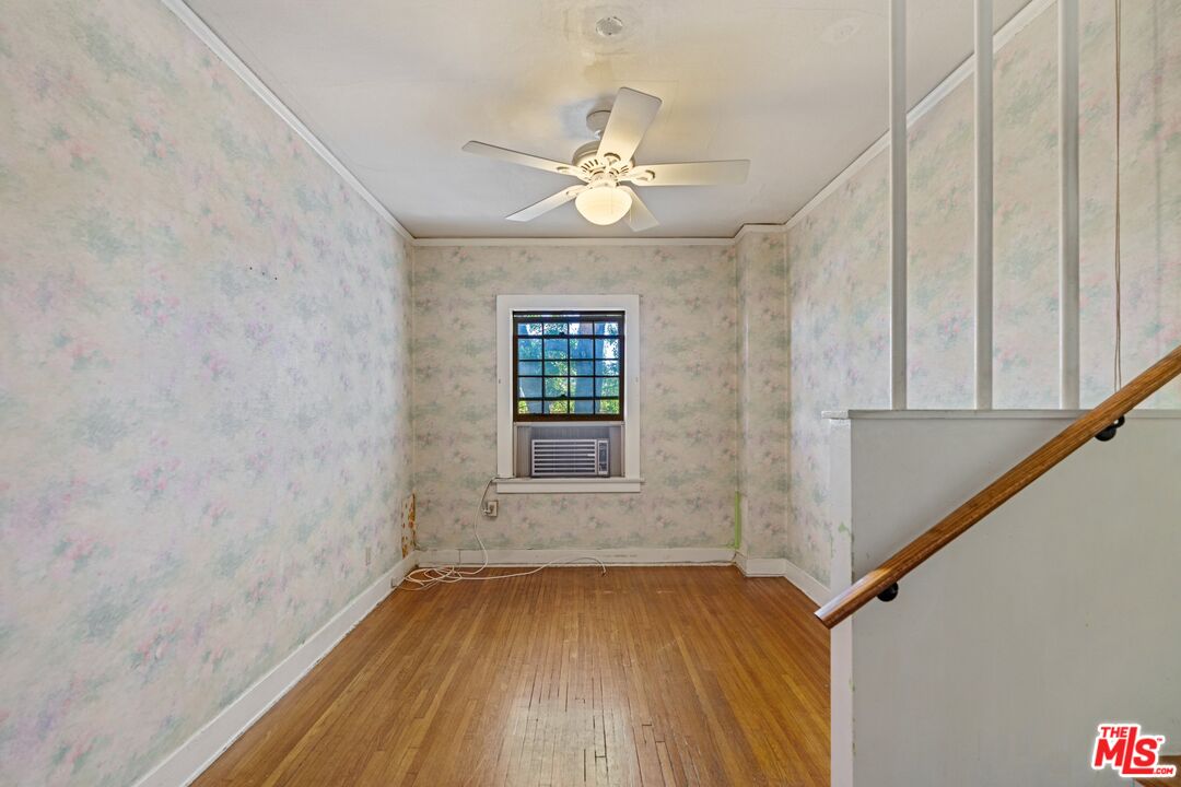 2429 North Commonwealth Avenue Los Angeles, CA 90027 - Photo 34 of 54 an empty room with wooden floor fan and windows