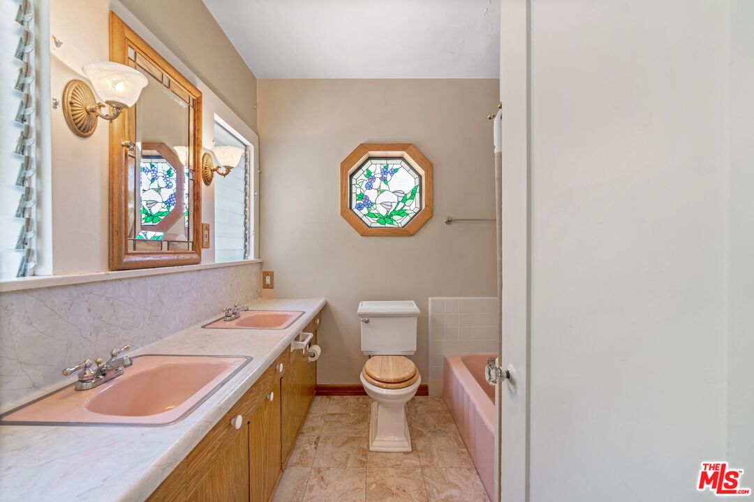 2429 North Commonwealth Avenue Los Angeles, CA 90027 - Photo 38 of 54 a bathroom with a granite countertop sink mirror vanity and toilet