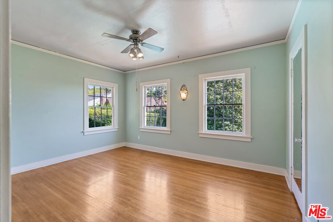 2429 North Commonwealth Avenue Los Angeles, CA 90027 - Photo 41 of 54 a view of an empty room with wooden floor and a window