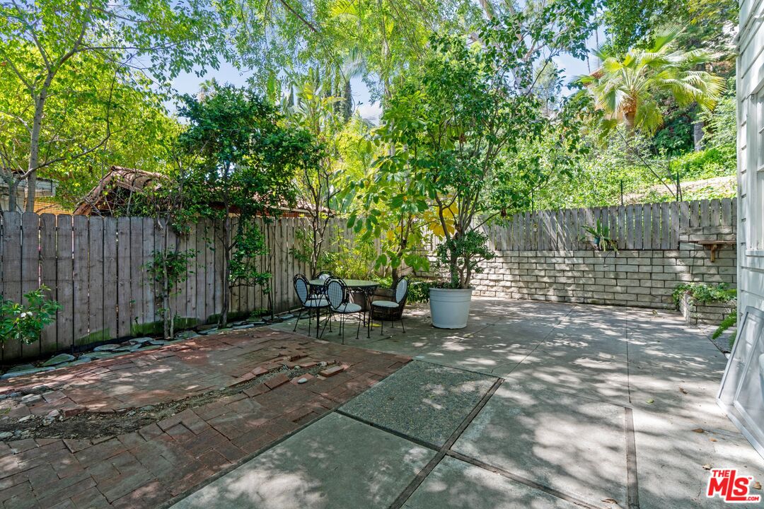 2429 North Commonwealth Avenue Los Angeles, CA 90027 - Photo 48 of 54 a view of a backyard with wooden fence and a large tree
