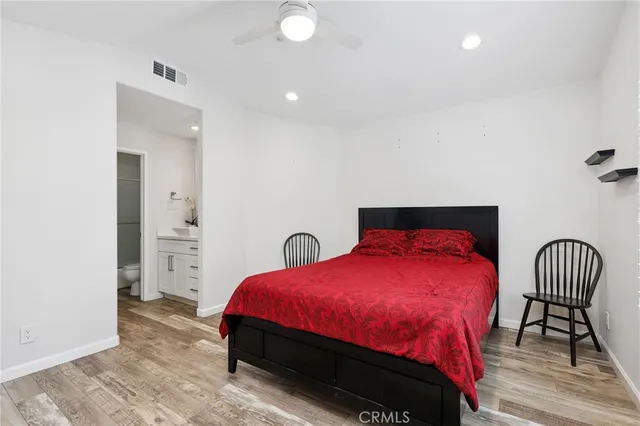 a bedroom with a bed and a chair