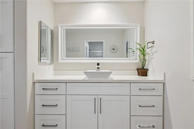 a bathroom with a sink a vanity and a mirror