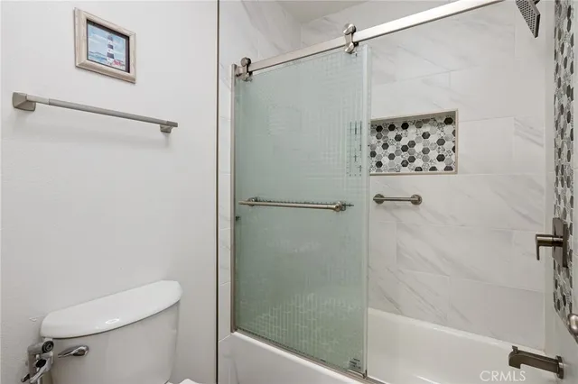 a bathroom with a shower and a toilet