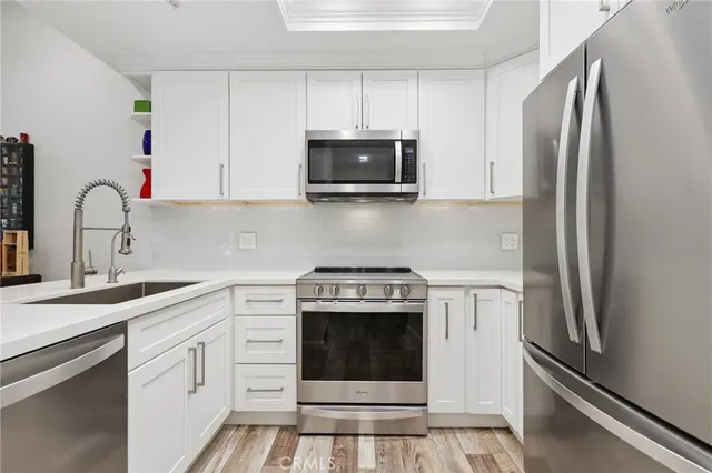a kitchen with a stove and a refrigerator