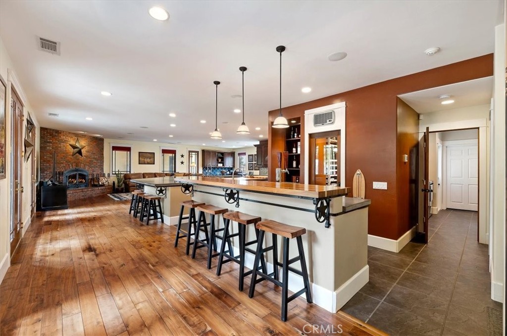 16420 Rocky Glen Road Perris, CA 92570 - Photo 15 of 74 a view of a kitchen with dining room and wooden floor
