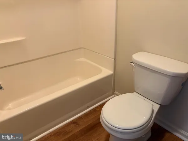 a bathroom with a toilet and a bathtub