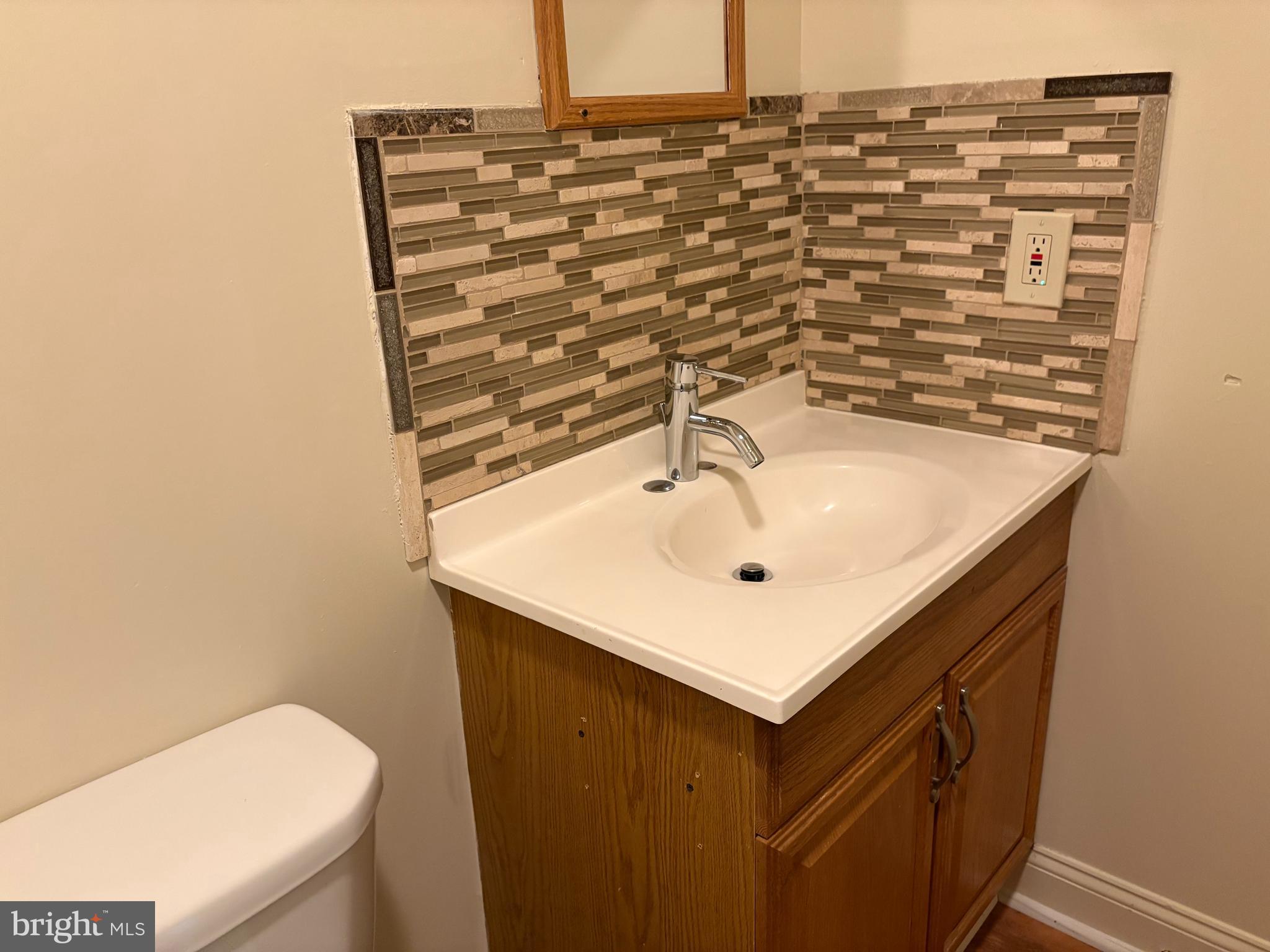 330 East Chestnut Street Coatesville, PA 19320 - Photo 12 of 17 a bathroom with a sink and a mirror