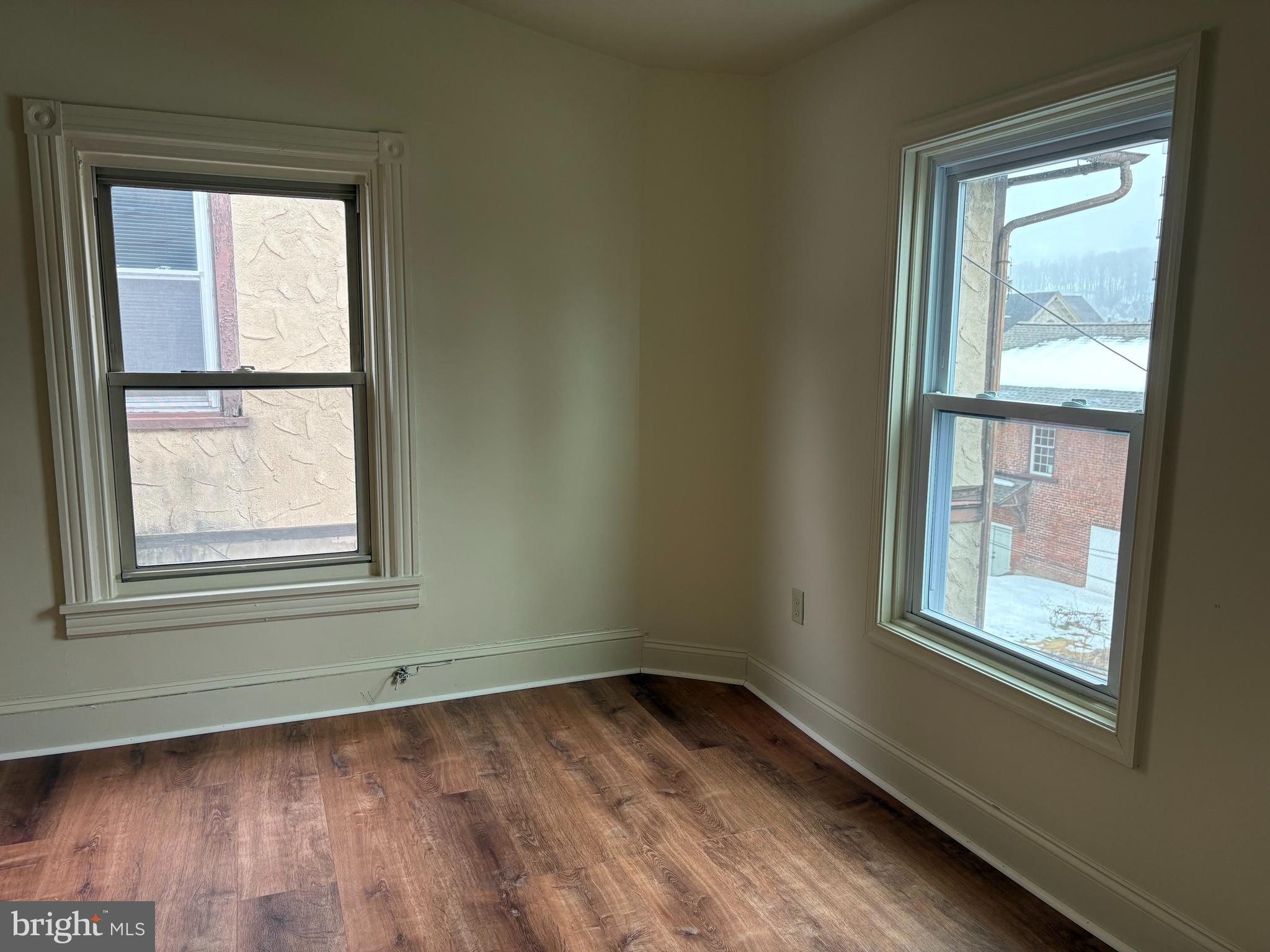 330 East Chestnut Street Coatesville, PA 19320 - Photo 13 of 17 an empty room with wooden floor and windows
