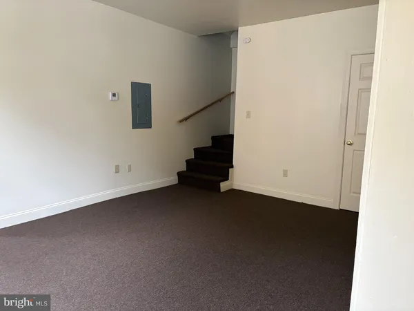 a view of an empty room with stairs