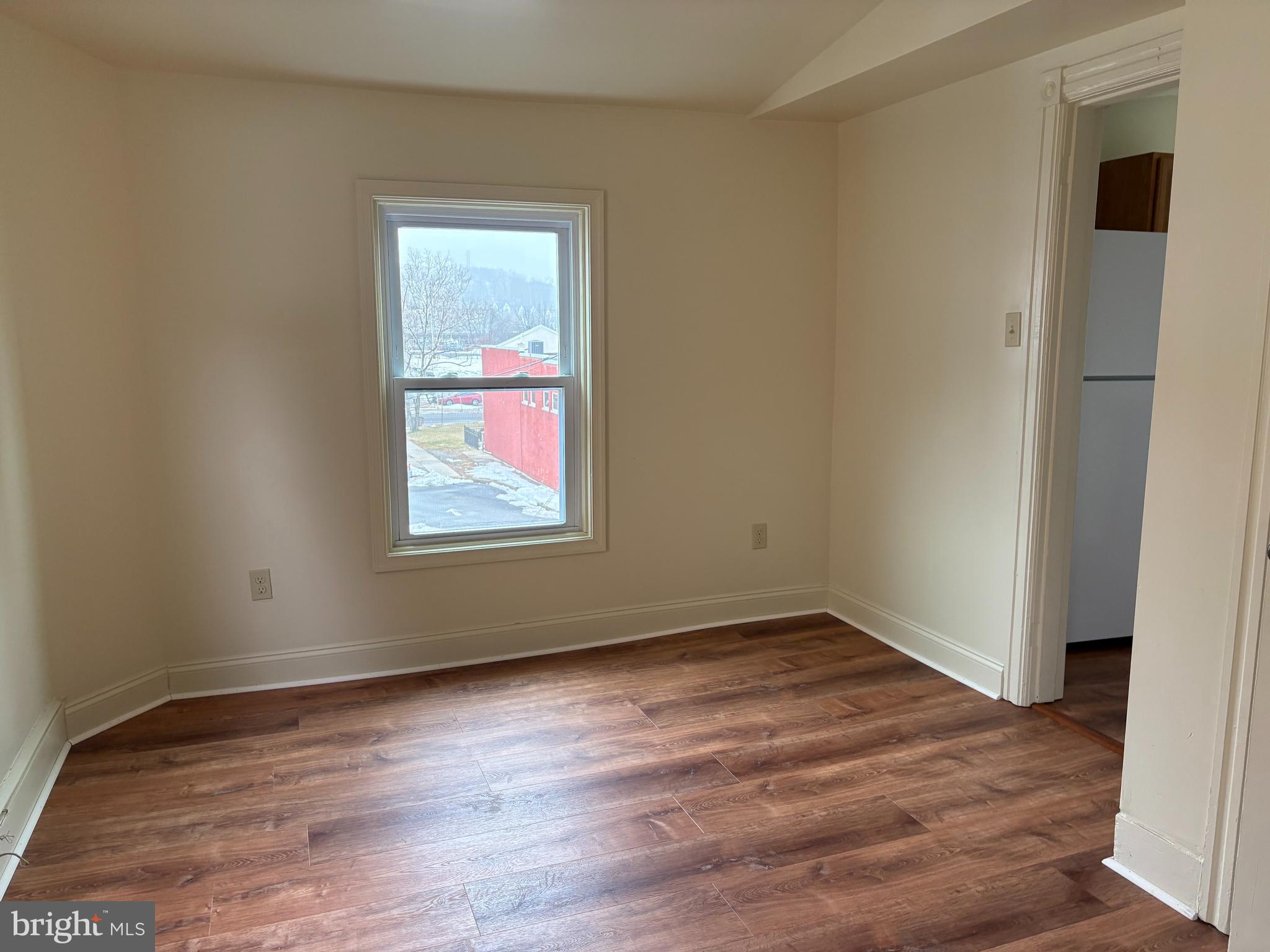 330 East Chestnut Street Coatesville, PA 19320 - Photo 5 of 17 an empty room with wooden floor and windows