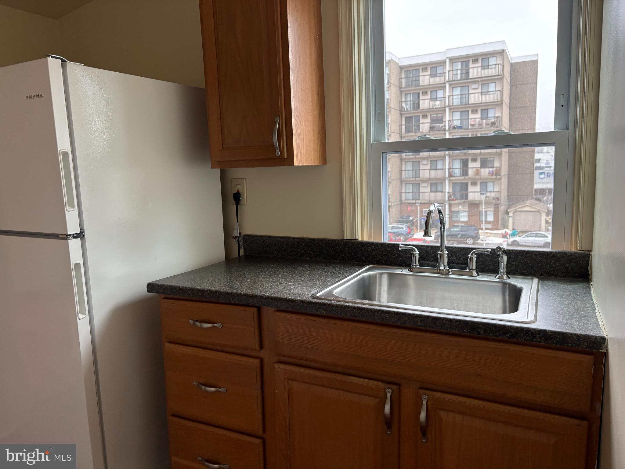 330 East Chestnut Street Coatesville, PA 19320 - Photo 9 of 17 a kitchen with a sink and a refrigerator