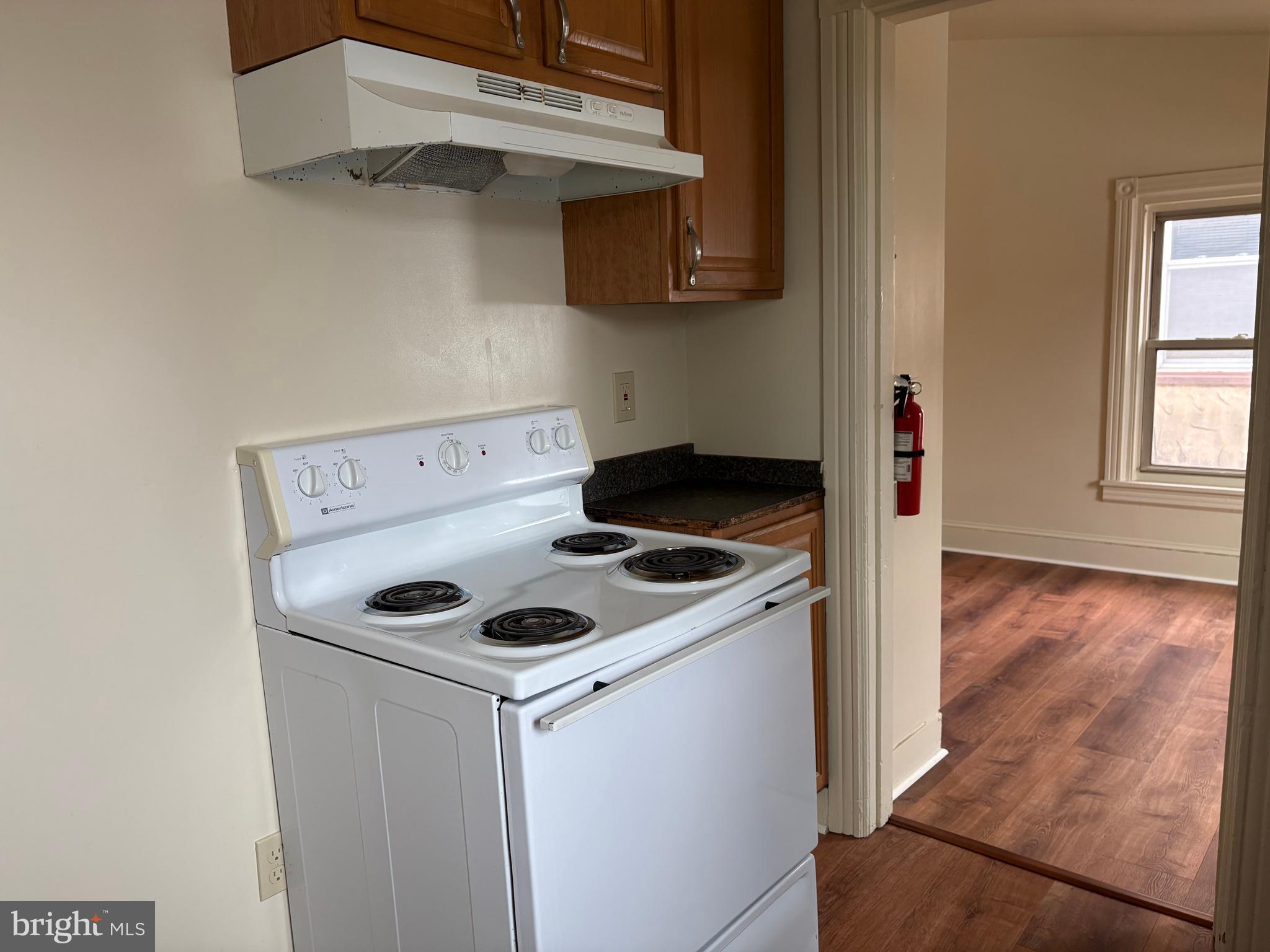 330 East Chestnut Street Coatesville, PA 19320 - Photo 10 of 17 a kitchen with a stove and a microwave