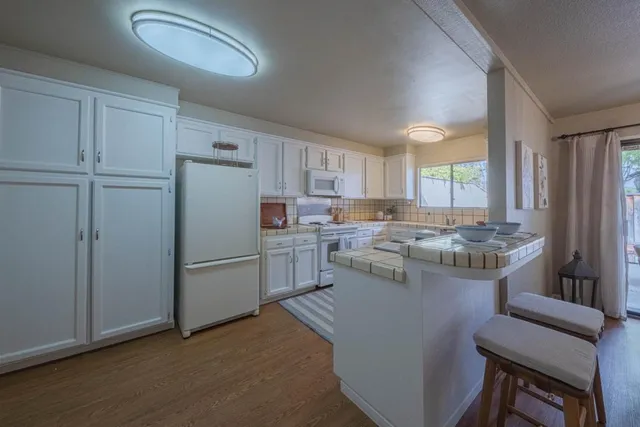 a kitchen with a refrigerator a sink and cabinets