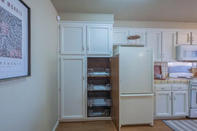 a utility room with cabinets washer and dryer