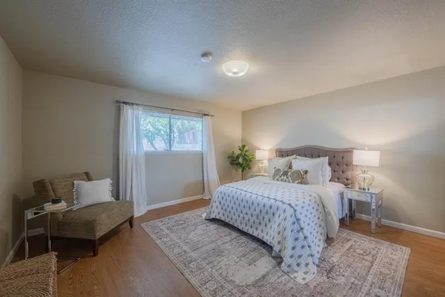 a bedroom with a bed and a mirror