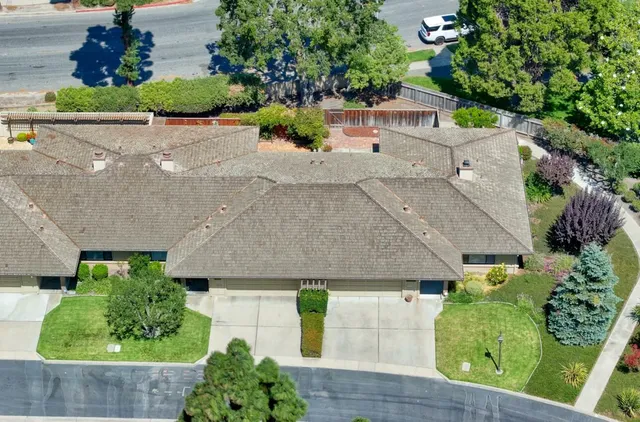 an aerial view of a house with a yard and a fountain