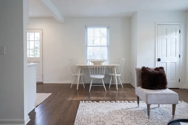 a dining room with furniture and wooden floor