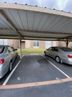 4748 Old Bent Tree Lane, Unit 207 Dallas, TX 75287 - Photo 20 of 20 a view of parking garage with cars parked
