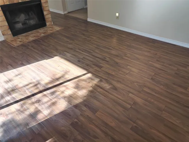 a view of wooden floor and brick wall