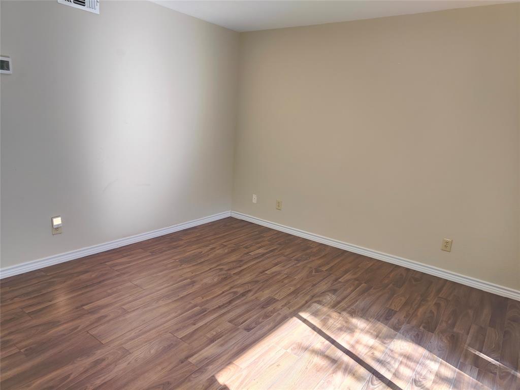 4748 Old Bent Tree Lane, Unit 207 Dallas, TX 75287 - Photo 5 of 20 a view of an empty room and wooden floor