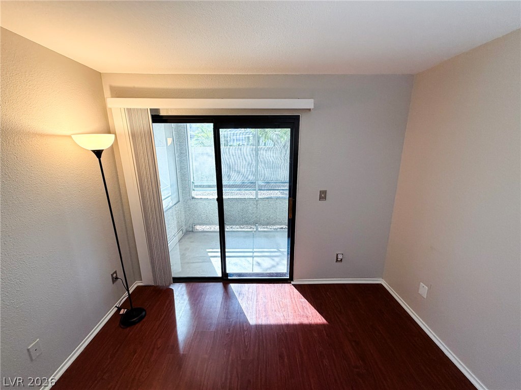5211 South Lindell Road, Unit 105 Las Vegas, NV 89118 - Photo 8 of 19 Rich wood flooring runs throughout this versatile interior space opening to a private patio.