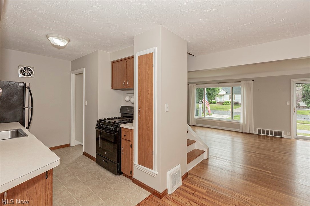 5523 Huron Road Lyndhurst, OH 44124 - Photo 10 of 34 Kitchen with wood and vinyl flooring, living room in the background