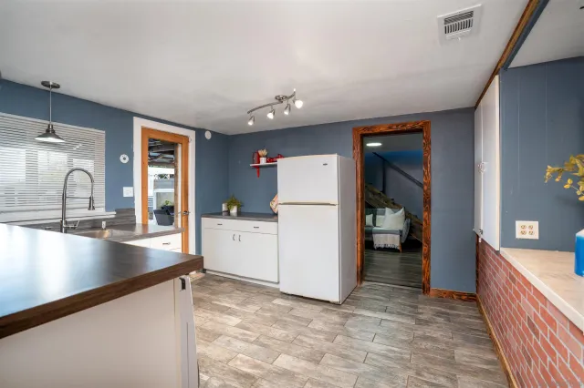 a kitchen with sink and refrigerator
