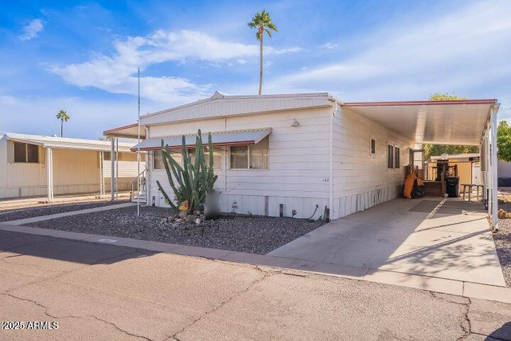 201 South Greenfield Road, Unit 142 Mesa, AZ 85206 - Photo 14 of 53 a view of a house with a ceiling fan and potted plants