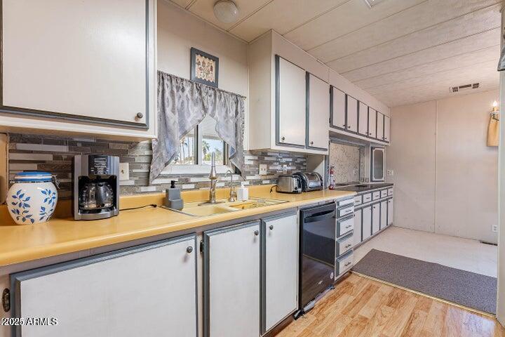 201 South Greenfield Road, Unit 142 Mesa, AZ 85206 - Photo 21 of 53 a kitchen with stainless steel appliances granite countertop a sink stove and cabinets