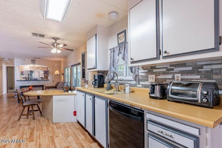 201 South Greenfield Road, Unit 142 Mesa, AZ 85206 - Photo 22 of 53 a kitchen with a sink a stove and cabinets