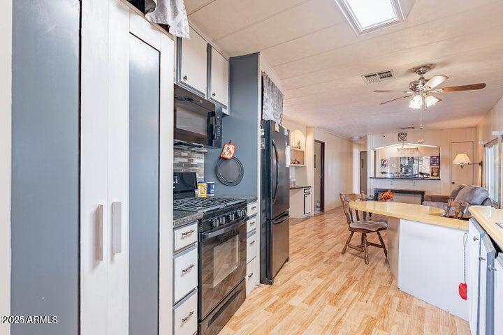 201 South Greenfield Road, Unit 142 Mesa, AZ 85206 - Photo 23 of 53 a view of a kitchen with a sink wooden floor and a window