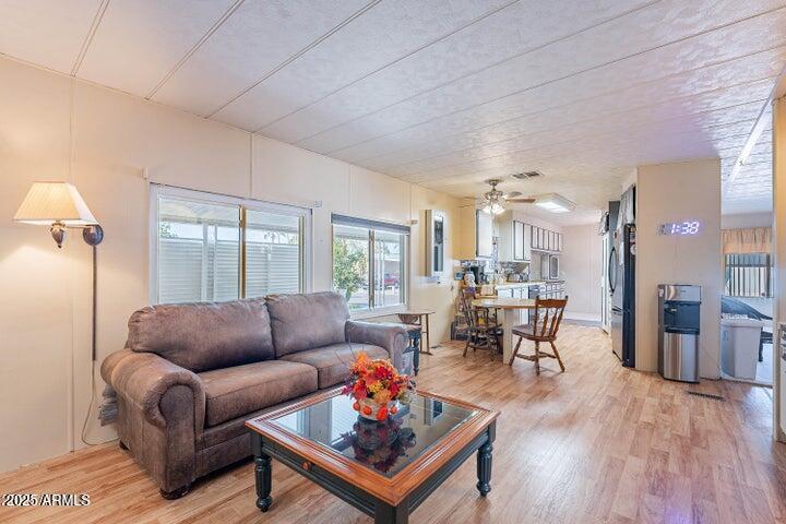 201 South Greenfield Road, Unit 142 Mesa, AZ 85206 - Photo 26 of 53 a living room with furniture and a wooden floor