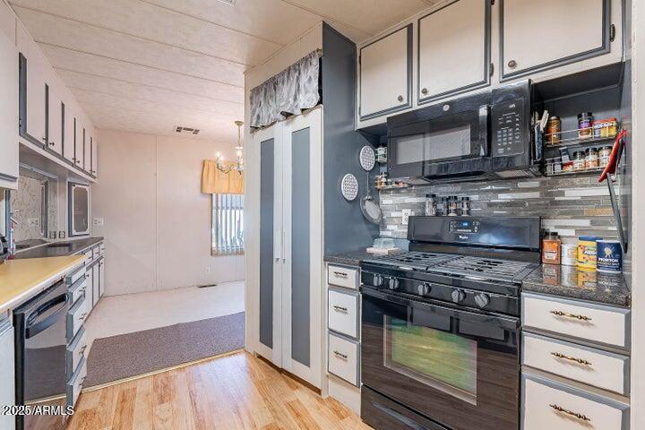 201 South Greenfield Road, Unit 142 Mesa, AZ 85206 - Photo 3 of 53 a kitchen with stainless steel appliances granite countertop a stove and a refrigerator