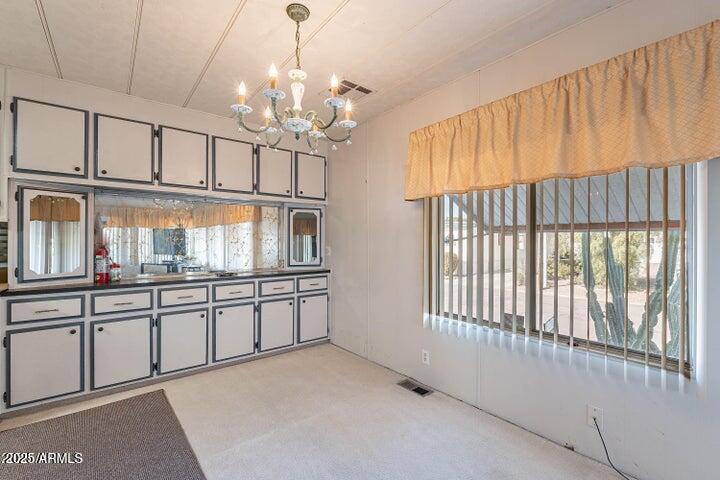 201 South Greenfield Road, Unit 142 Mesa, AZ 85206 - Photo 4 of 53 a kitchen with granite countertop a sink and cabinets