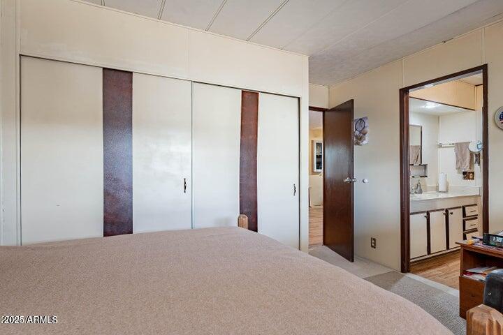 201 South Greenfield Road, Unit 142 Mesa, AZ 85206 - Photo 8 of 53 a bedroom with a bed and a chandelier